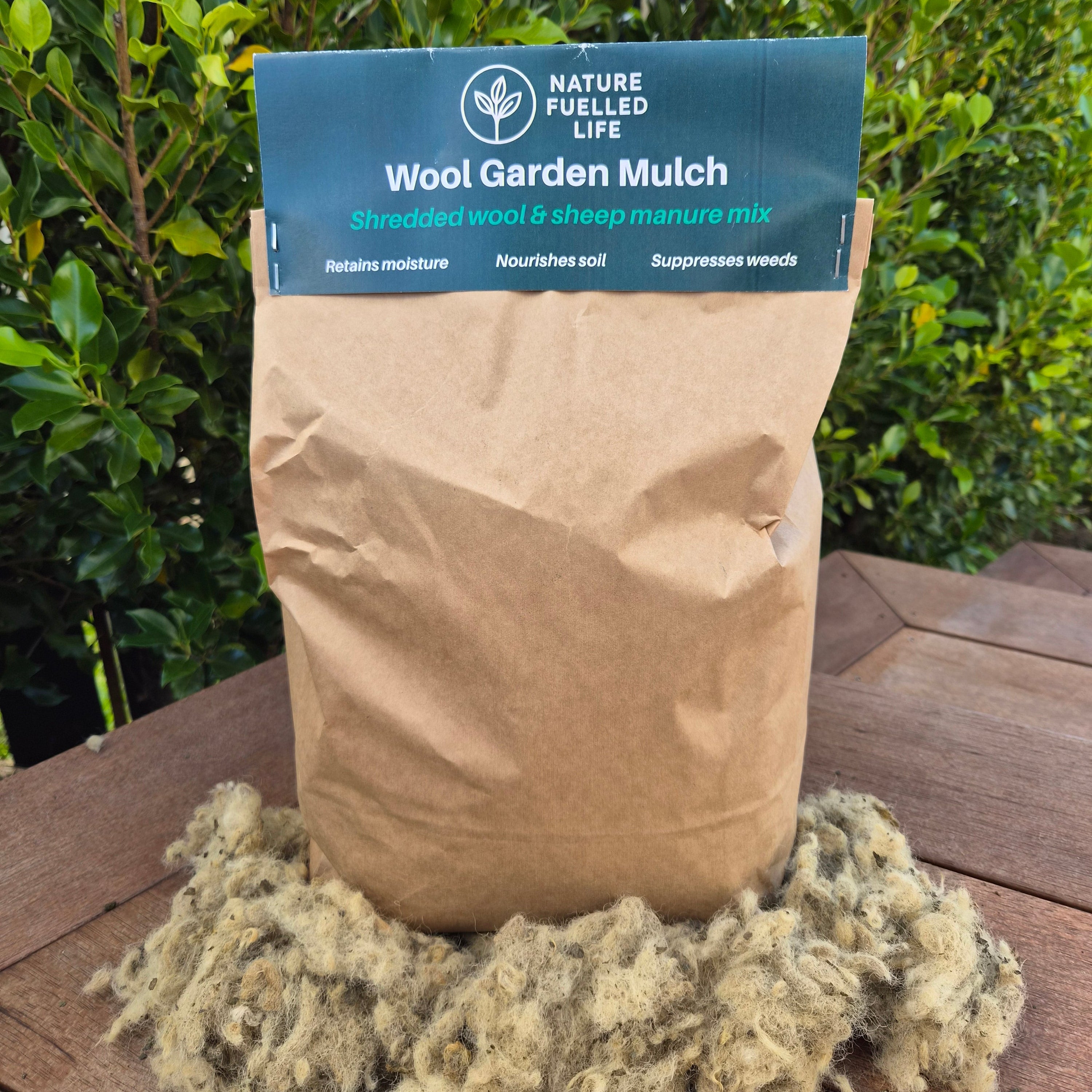 Bag of wool garden mulch with a visible brand label against a natural background